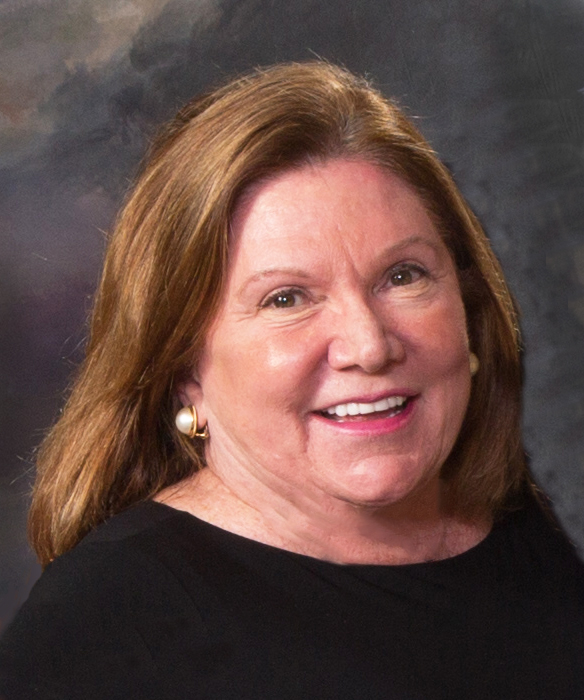 Gail gordon in a black blouse in front of a gray background