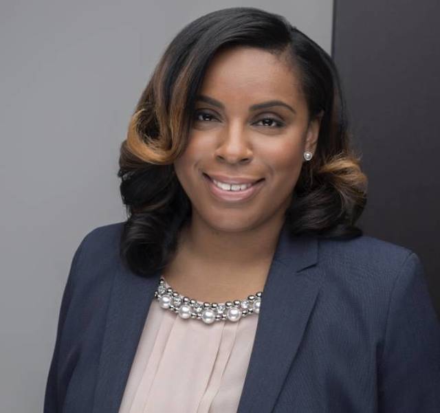 LaMonica McIver in a navy blue blazer and light pink blouse