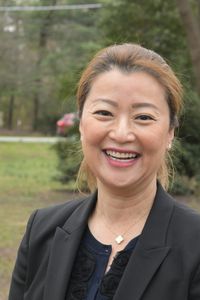 Ellen Park in a black blazer outside in front of a blurred background