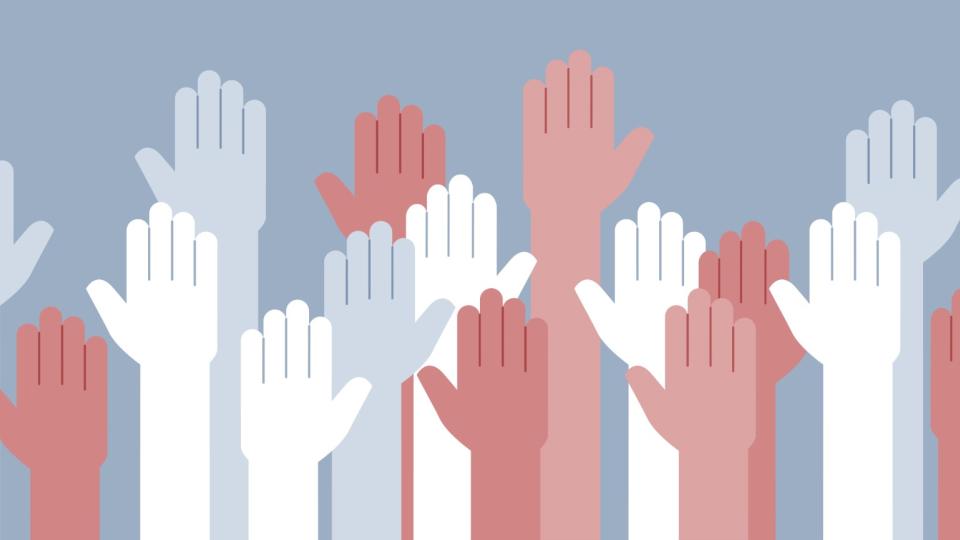 Diverse group of raised hands.