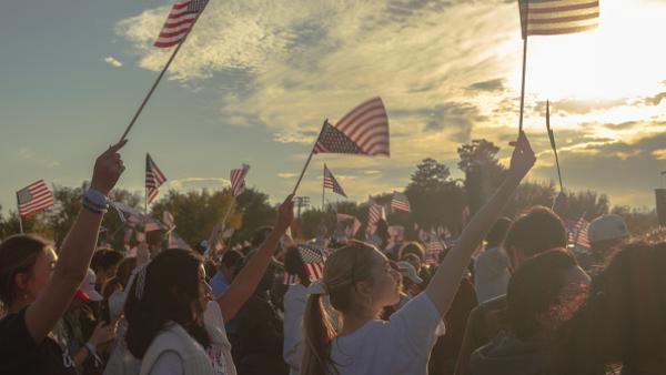 Young women waving American flags