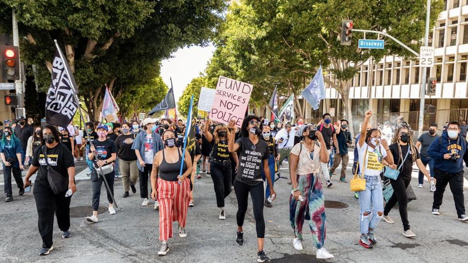 black lives matter protesters marching with signs