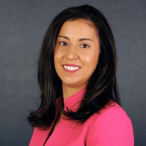Arlene Perez in pink jacket against blue background