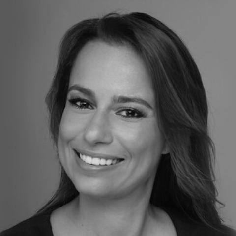 Black and white head shot of Julie Roginsky against a blank background