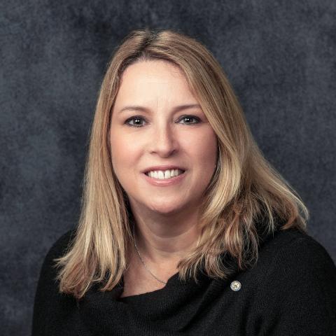 Head shot of Assemblywoman Kim Eulner wearing a black jacket against a gray background