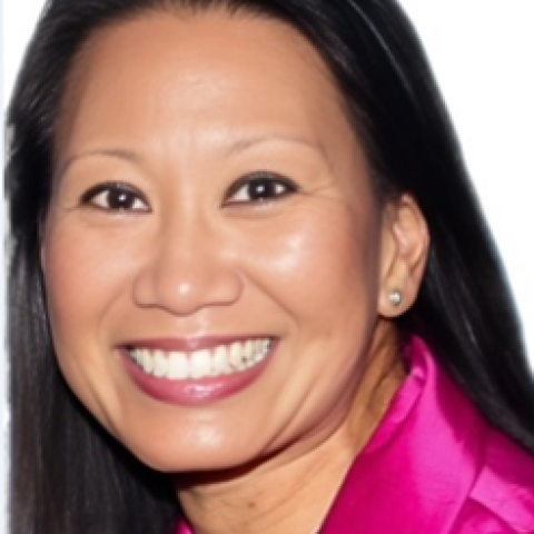 Headshot of Cheryl Quinio-Blodgett wearing a bright pink suit jacket 