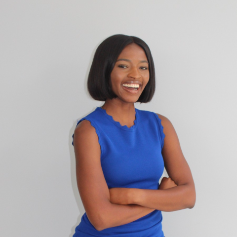 Medinah Muhammad smiling in a bright blue dress