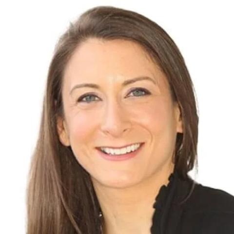 Headshot of Chrissy Buteas smiling at the camera against a white background