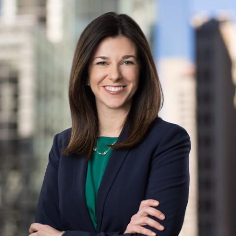 Jennifer Duffy smiling at the camera, arms crossed over her chest 