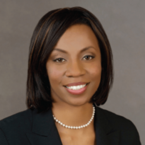 Angela Garretson in black jacket against a gray background