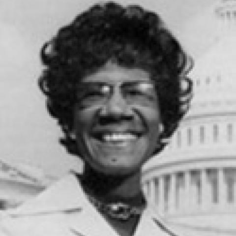 2000 Lipman Chair Former Congresswoman Shirley Chisholm smiling in front of US Capitol