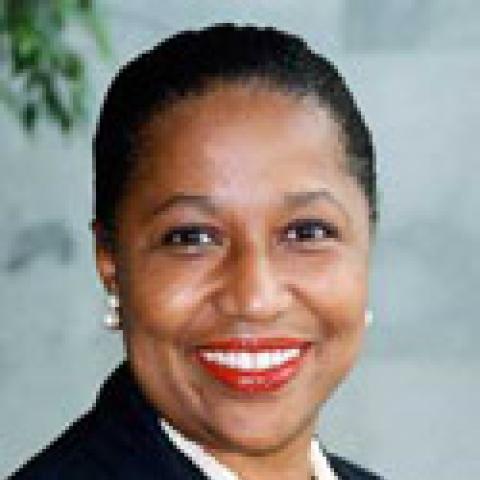 2004 Lipman Chair Ambassador Carol Moseley Braun smiling in black suit and white necklace