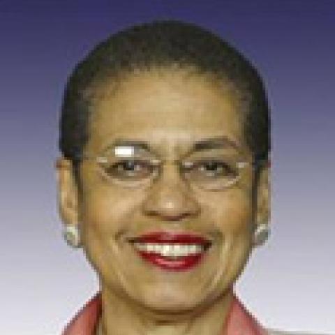 2006 Lipman Chair Congresswoman Eleanor Holmes Norton smiling in front of purple gradient background