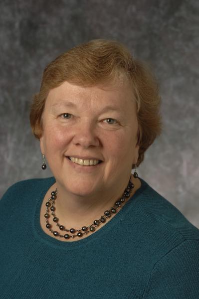 Sue Carroll head shot against gray background