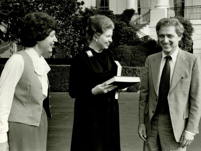 CAWP director Ruth B. Mandel and Rutgers president Edward J. Bloustein present CAWP's Women in Public Office directory (2nd edition) to Sarah Weddington, Assistant to President Jimmy Carter, on the White House Lawn, 1978.