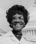 Shirley A. Chisholm smiling in front of US Capitol building