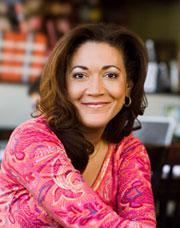 Michele Norris smiling wearing a pink printed top