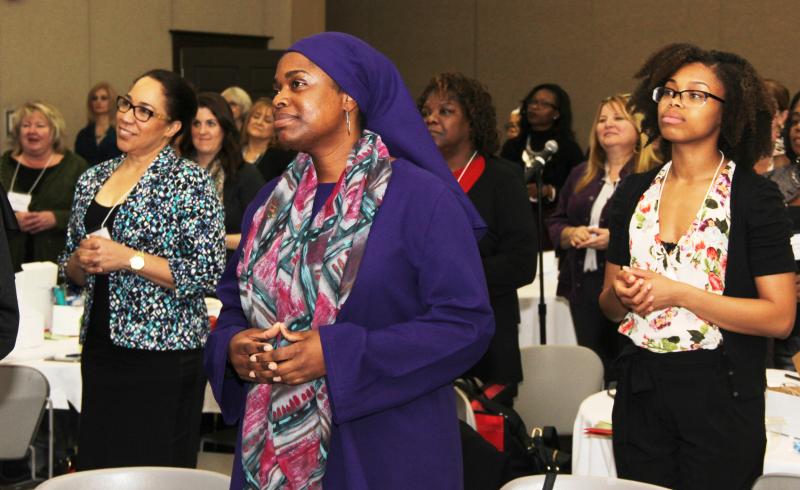 Women standing in conference room.