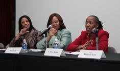 Three African American women seated in front of microphones