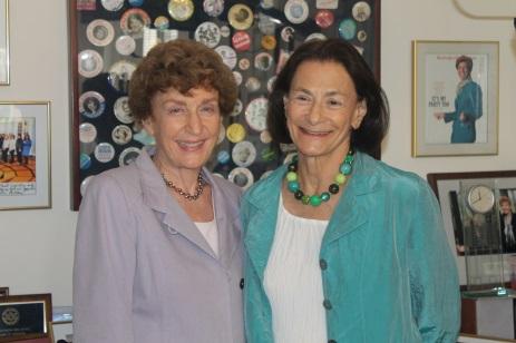 Ruth and Ida smiling in front of a display of political buttons