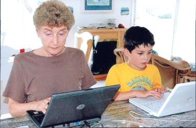 Ruth and her grandson working at their computers