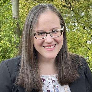 Tarah Willians in a black blazer in front of trees