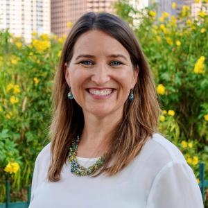Heidi Gerbracht in a white shirt in front of greenery outside