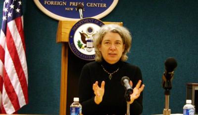 Ethel Klein in front of wood podium, American flag
