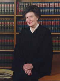 Marie Garibaldi smiles in black judge's robe 